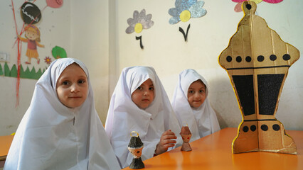 Kindergarten children wearing prayer clothes to celebrate of Ramadan. Ramadan Crescent.