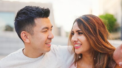 Fototapeta premium Multiethnic couple on the street looking at each other