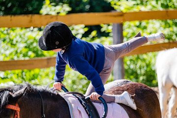 boy doing exercises on a horse