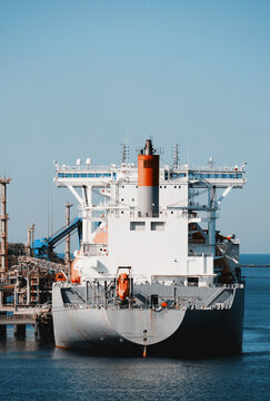 Liquefied Natural Gas Carrier LNG Tanker Connected To Marine Loading Arm For Cargo Transfer Operation