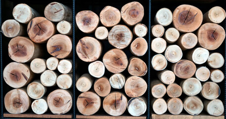 The wooden logs are stacked together to show the circular cross-sectional pattern of each log used for decorating various corners in resorts, houses, and places in vintage style.