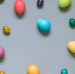 Colorful painted Easter eggs on the grey background. Top view. Copy space