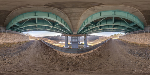 hdri 360 panorama on gravel road under steel frame construction of huge car bridge across river in...