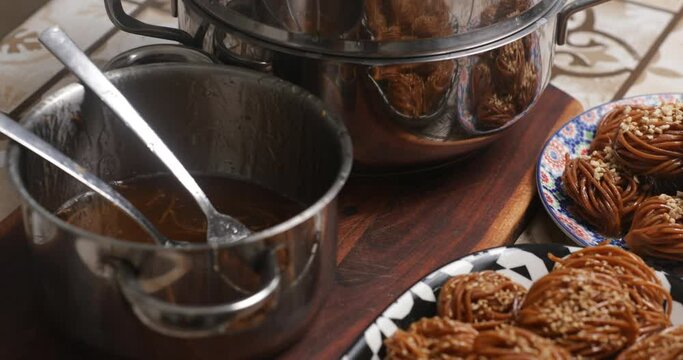 With practiced hands, the homemaker dips chebakia into warm honey, each dunk infusing the traditional pastry with the sweetness of familial tradition and culinary heritage