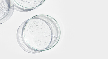 Petri dish. Petri cups with liquid. Kit. Chemical elements, oil, cosmetics. Gel, water, molecules, viruses. Close-up. On a white background.