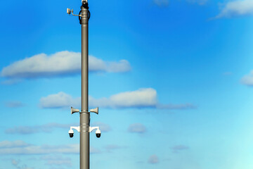 The concept of control and management of society. Pole with surveillance cameras and loudspeakers
