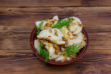 Delicious homemade dumplings on a wooden table