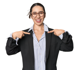 Confident young Caucasian businesswoman on studio background surprised pointing with finger, smiling broadly.