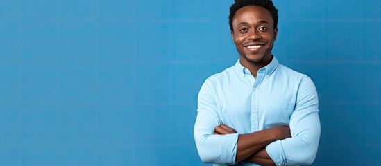 Confident Young Man Standing with Crossed Arms Showing Determination and Assertiveness - obrazy, fototapety, plakaty
