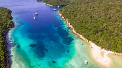  Sivota - stunning aerial drone video of turquoise sea known as Blue Lagoon and unique beach Bella Vraka. Epirus, Greece © Freesurf