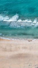 waves on the beach drone shot from the top