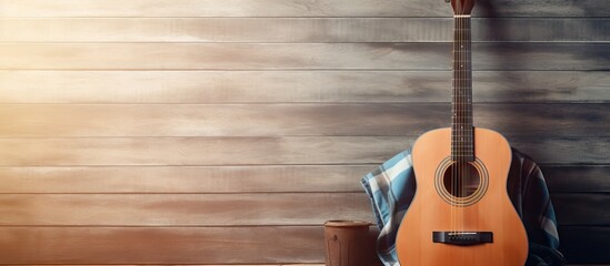 Vintage Acoustic Guitar Resting on Rustic Wooden Background with Guitar Case Nearby - obrazy, fototapety, plakaty