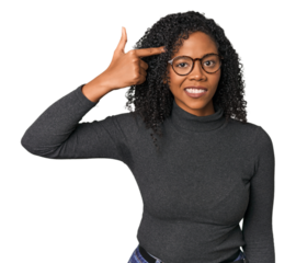 African American woman in studio setting showing a disappointment gesture with forefinger.