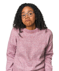 African American woman in studio setting shrugs shoulders and open eyes confused.