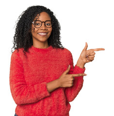 African American woman in studio setting excited pointing with forefingers away.