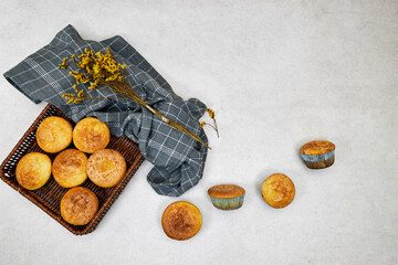 Pan Vanilla Caramel Nuts Muffins In Paper Cups in esparto halvah basket with gypsophila flower