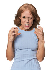 Redhead mid-aged Caucasian woman in studio upset screaming with tense hands.