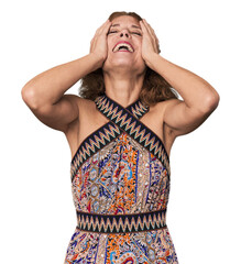 Redhead mid-aged Caucasian woman in studio laughs joyfully keeping hands on head. Happiness concept.