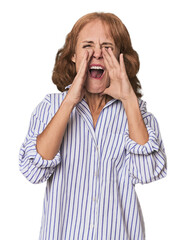 Redhead mid-aged Caucasian woman in studio shouting excited to front.