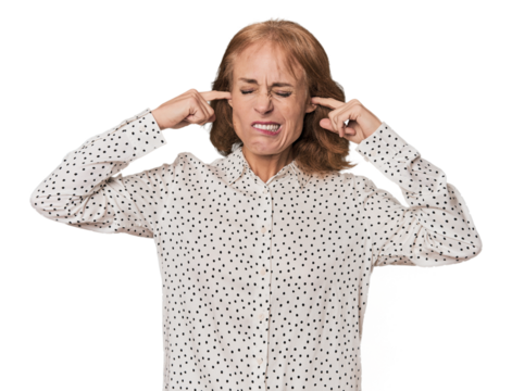 Redhead mid-aged Caucasian woman in studio covering ears with fingers, stressed and desperate by a loudly ambient. - Powered by Adobe