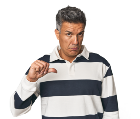 Middle-aged Latino man showing a dislike gesture, thumbs down. Disagreement concept.
