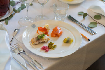 A plate of salmon and caviar on a table in a restaurant