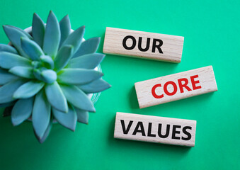 Our core values symbol. Concept words Our core values on wooden blocks. Beautiful green background...