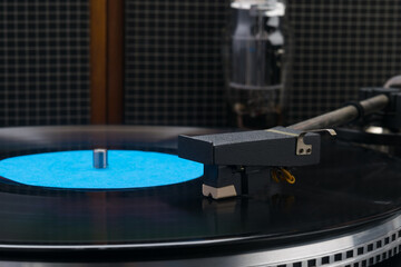 against the background of music player speakers, close-up of a vinyl record