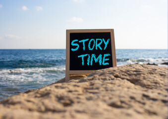Story Time symbol. Concept word Story Time on black chalk background. Beautiful sea background. Business and Story Time concept. Copy space