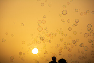 Lots of soap bubbles in the sky at sunset