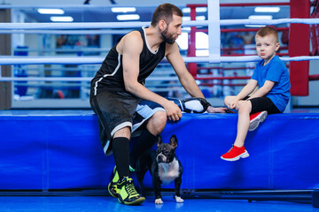 Boxing trainer talks to boy boxer, child lost championship fight in ring. Concept psychology in...
