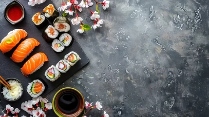 Sierkussen sushi on gray concrete table with spring flowers, sushi for Easter, background with copy space © Nastya