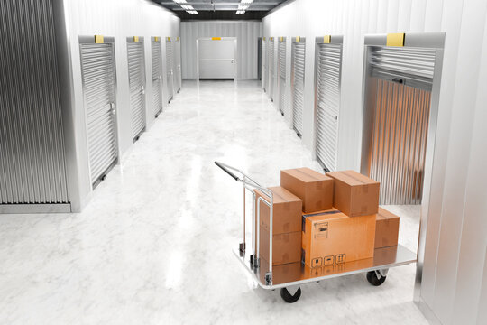Storage rooms. Warehouse corridor with individual containers. Warehouse cart with boxes. Storage rooms for rent. Storehouse without people. Storage rooms with closed roller shutters. 3d image