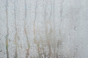 Rainwater drops on a transparent background made of waterproof fabric. Texture and abstract...
