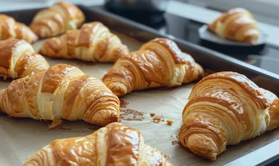 Tuinposter freshly baked croissants on the baking sheet © Pter