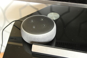 smart speakers virtual assistant on a black television stand in a living room