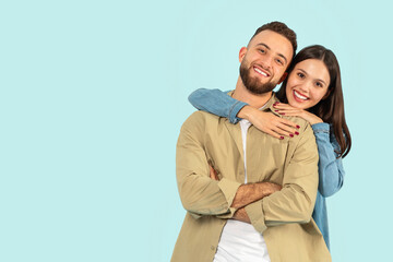 Happy European Young Couple Hugging While Posing Over Blue Backdrop