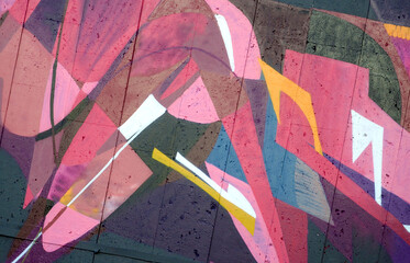 Colorful background of graffiti painting artwork with bright aerosol outlines on wall. Old school...