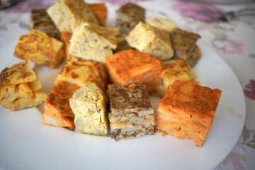 Close-up of assorted Spanish omelettes on a white plate