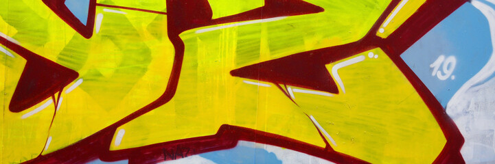 Colorful background of graffiti painting artwork with bright aerosol outlines on wall. Old school...