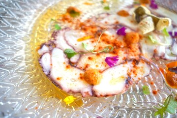 Octopus elegantly plated with colorful accents