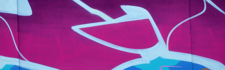 Colorful background of graffiti painting artwork with bright aerosol outlines on wall. Old school...