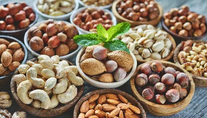 Foto op Aluminium colorful mix of various nuts peanut and cashew hazelnut and almond pine nuts and walnut healthy diet snack vegan food background © Claudio