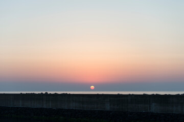 View of the sunset over the seawall