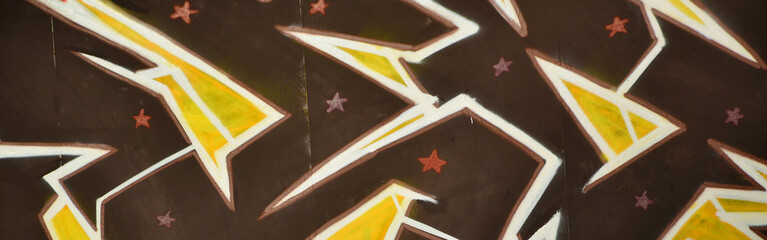 Colorful background of graffiti painting artwork with bright aerosol outlines on wall. Old school...