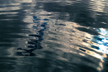 Calm waves on the surface of dark water