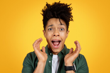 Closeup of african american man screaming over yellow background