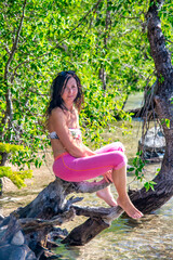 A happy woman reaxing along the lake in summer season - 755117257