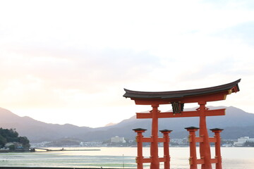 Famous red torii (shinto shrine gates) of the Itsukushima Shrine on sunset, Miyajima, Japan. High quality photo