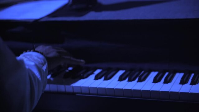 Black pianist playing on stage